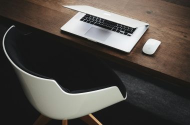 Apple MacBook beside computer mouse on table