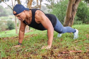 a man is doing push ups in the grass