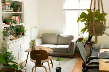 gray fabric loveseat near brown wooden table